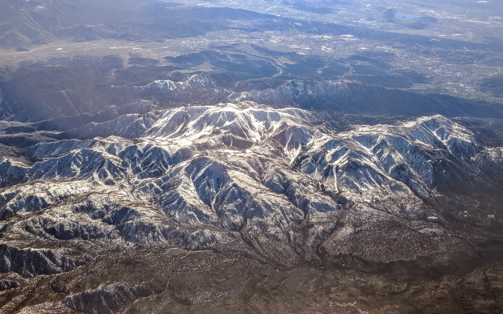 Aerial view of Mount San Gorgonio with snow, San Gorgonio Pass, and Banning, California